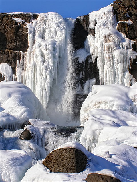 Frozen waterfall Oxarafoss in Thingvellir National Park, Iceland
